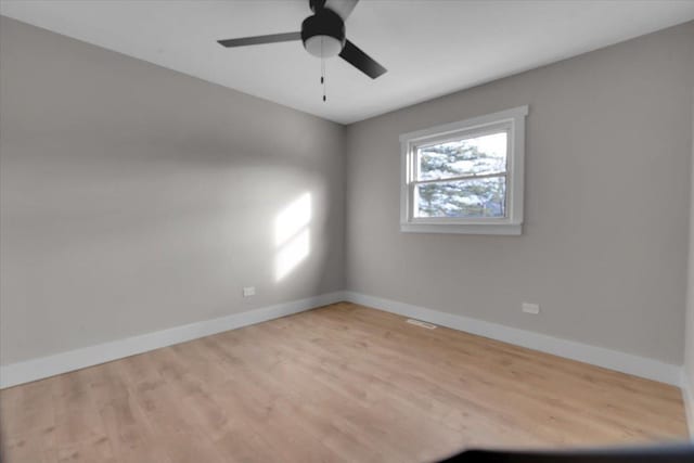 unfurnished room with light wood-type flooring and ceiling fan