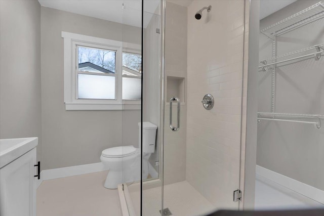 bathroom featuring toilet and an enclosed shower