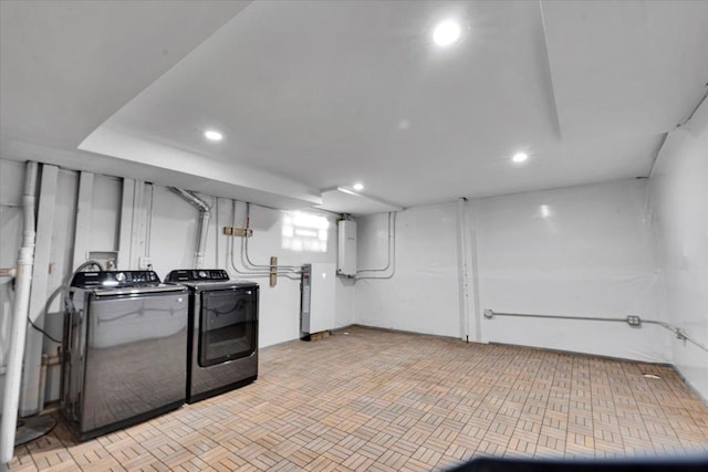 clothes washing area with washing machine and clothes dryer and electric panel