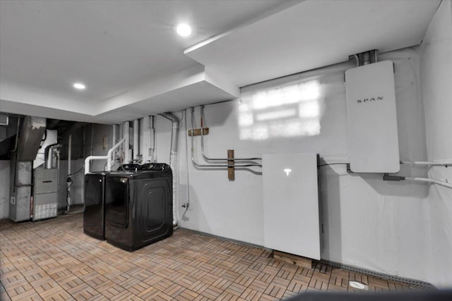 laundry room featuring independent washer and dryer and heating unit