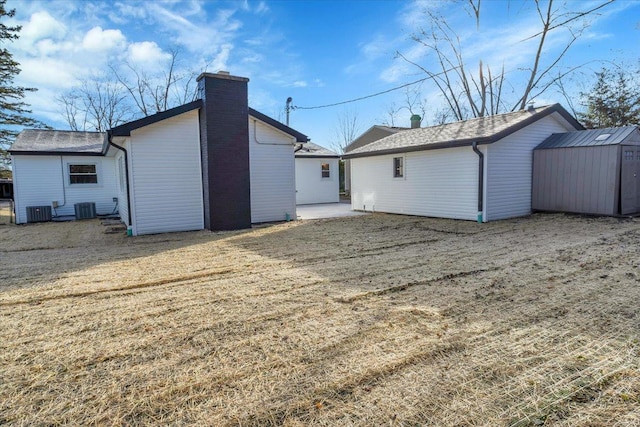 back of property featuring a storage unit and central air condition unit