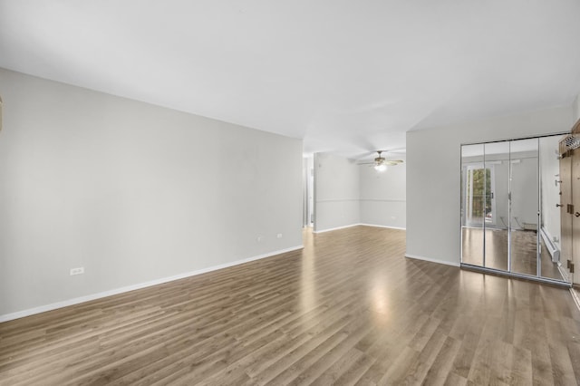 empty room with wood-type flooring and ceiling fan