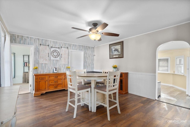 dining room with ceiling fan, dark hardwood / wood-style floors, and ornamental molding