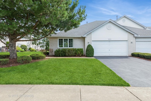 single story home featuring a front yard and a garage