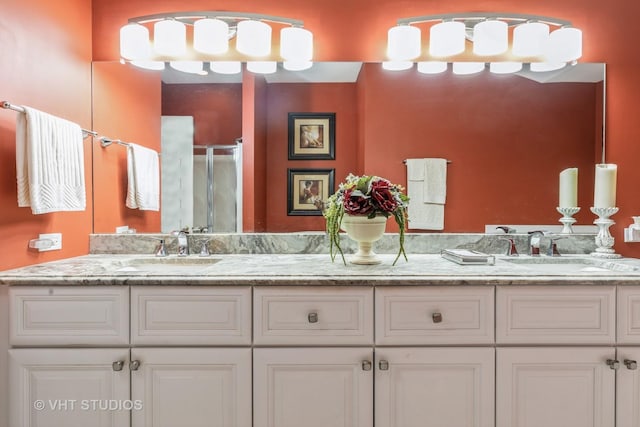 bathroom featuring vanity and an enclosed shower