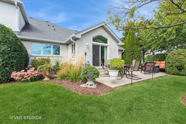 back of property featuring a patio and a lawn