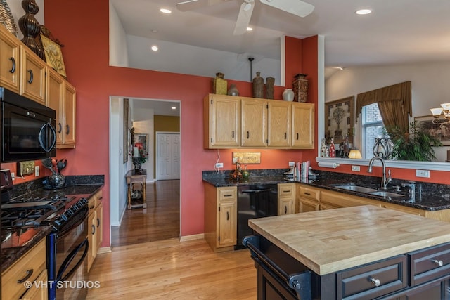 kitchen with black appliances, sink, ceiling fan, light wood-type flooring, and butcher block counters