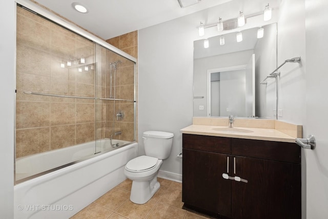 full bathroom featuring tile patterned flooring, bath / shower combo with glass door, vanity, and toilet