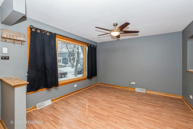 spare room featuring ceiling fan and light hardwood / wood-style flooring