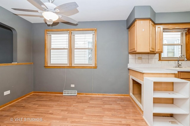 kitchen featuring ceiling fan, light brown cabinetry, a wealth of natural light, and tasteful backsplash