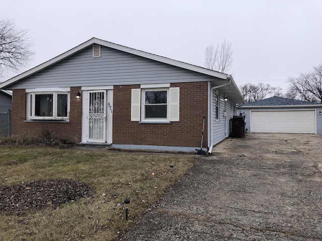 view of front facade with a front yard, a garage, and an outdoor structure