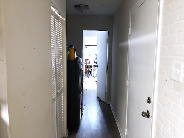 hallway featuring washer and dryer and dark wood-type flooring