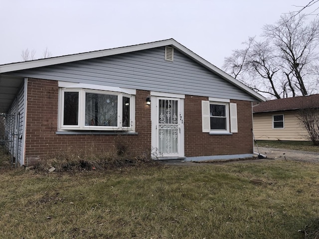 bungalow-style house featuring a front yard