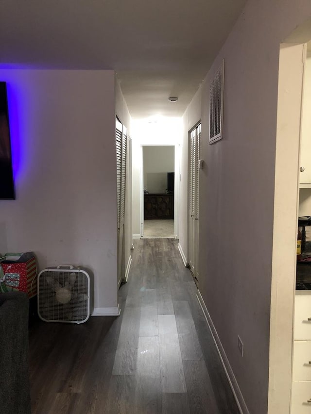 corridor with dark hardwood / wood-style floors