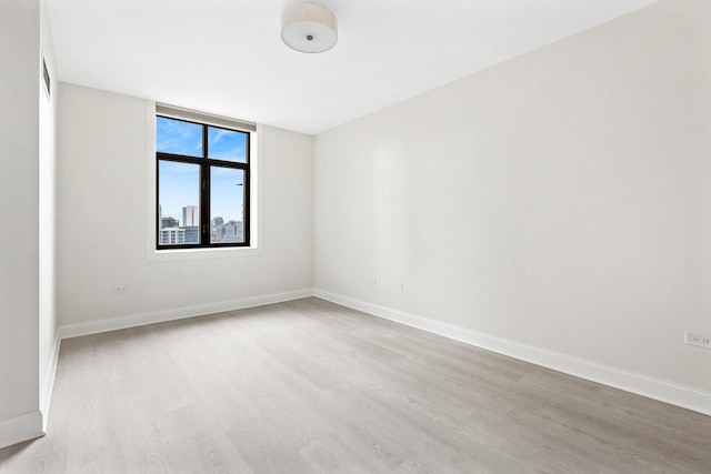 spare room featuring light wood-type flooring