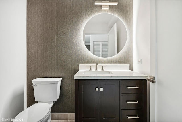 bathroom featuring vanity and toilet