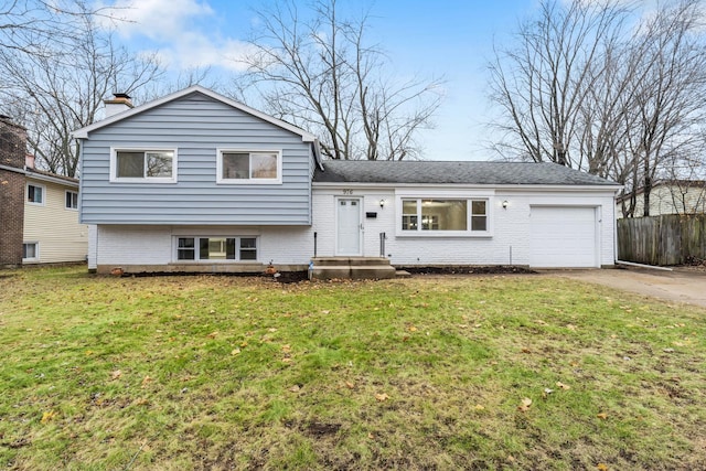 tri-level home with a front lawn and a garage