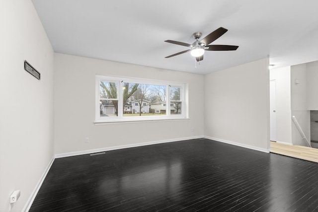 spare room featuring wood-type flooring and ceiling fan