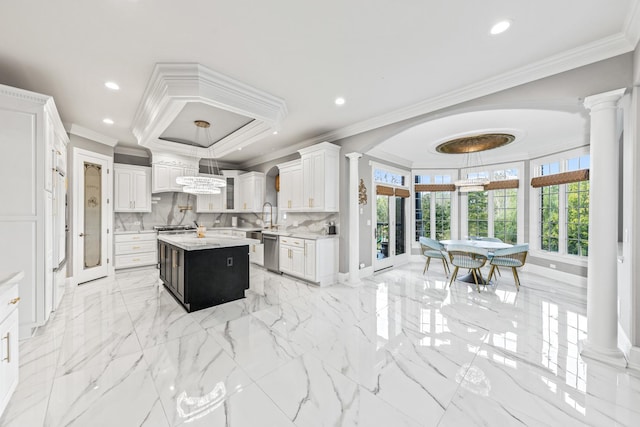 kitchen featuring dishwasher, a center island, crown molding, tasteful backsplash, and white cabinetry