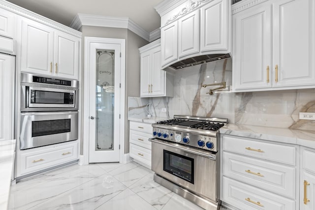 kitchen featuring tasteful backsplash, light stone counters, stainless steel appliances, crown molding, and white cabinetry