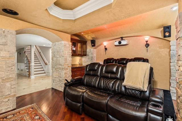 cinema featuring dark hardwood / wood-style floors and ornamental molding