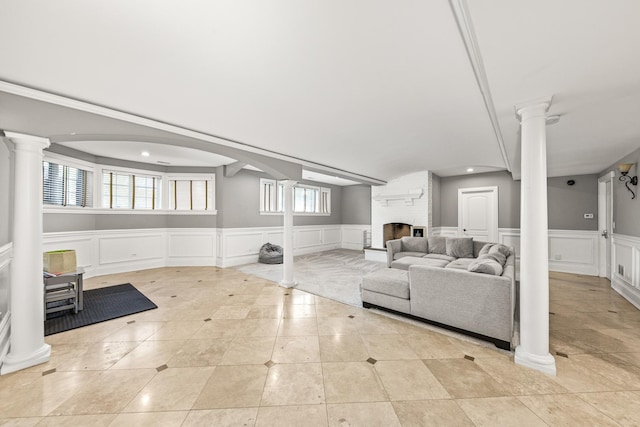 living room featuring a fireplace, light tile patterned floors, and a healthy amount of sunlight