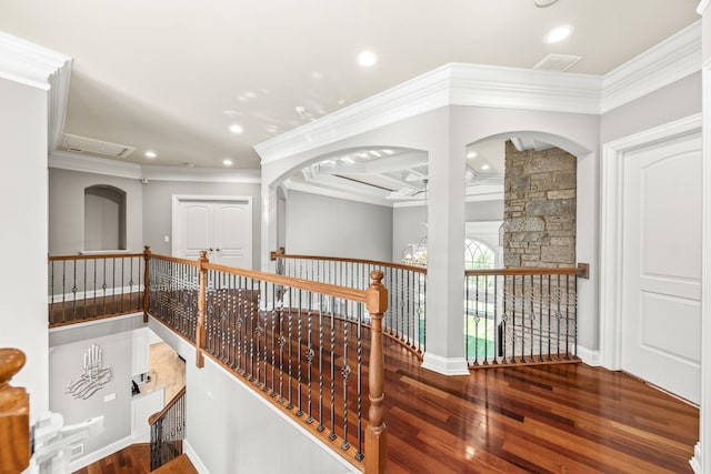 corridor with wood-type flooring, crown molding, and coffered ceiling