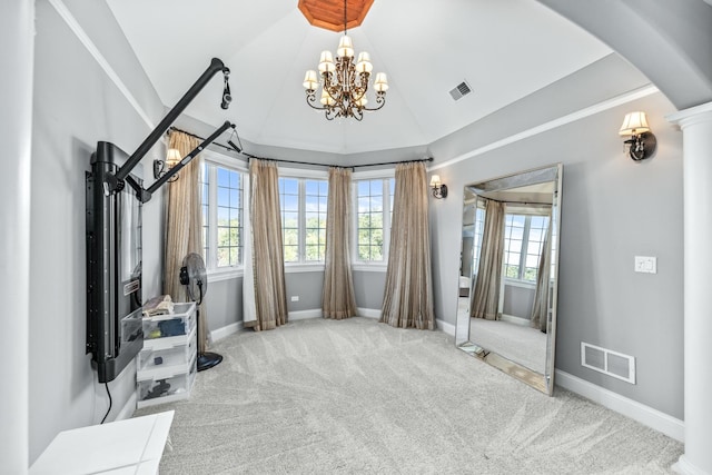 interior space with carpet floors, lofted ceiling, and a notable chandelier