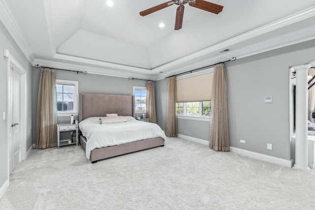 carpeted bedroom with a tray ceiling, ceiling fan, and ornamental molding