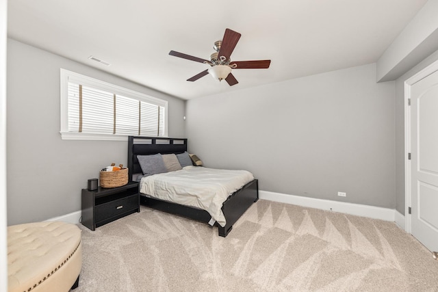 bedroom with ceiling fan and light carpet