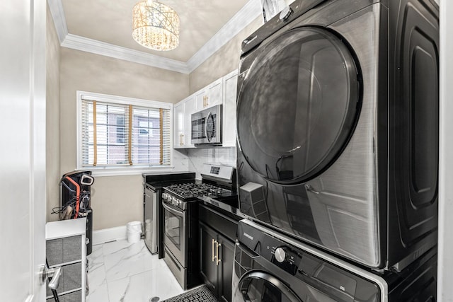 laundry area with stacked washer and dryer, an inviting chandelier, and ornamental molding