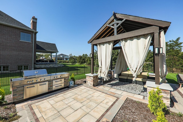 view of patio with a gazebo, area for grilling, and exterior kitchen