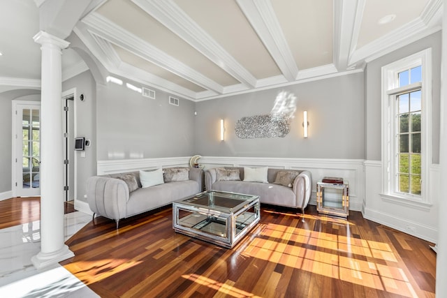 living room with hardwood / wood-style floors, ornate columns, and ornamental molding