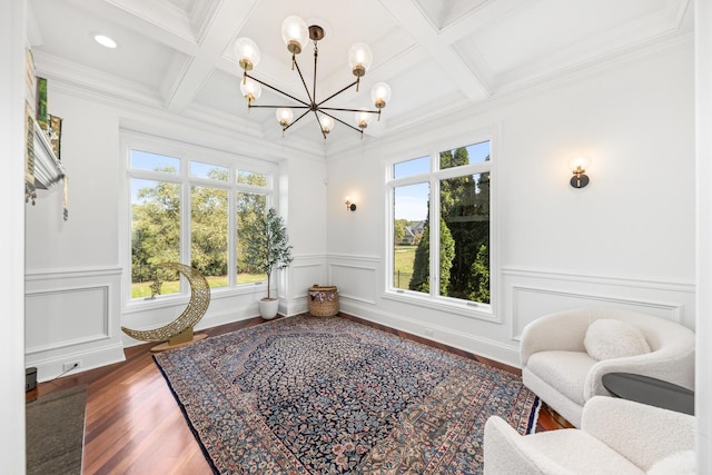 sitting room with beam ceiling, hardwood / wood-style floors, a chandelier, and coffered ceiling