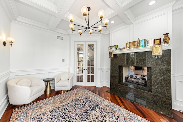 living room featuring a high end fireplace, french doors, beamed ceiling, and coffered ceiling