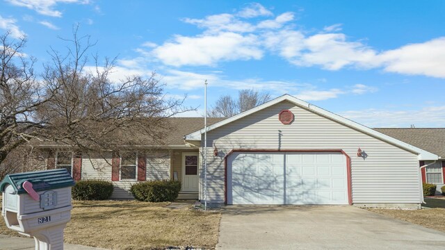 ranch-style home with a yard and a garage