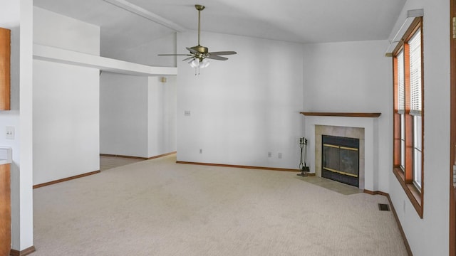 unfurnished living room with lofted ceiling with beams, carpet, a fireplace, and baseboards