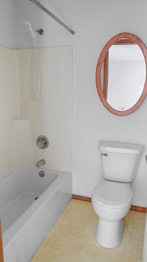 bathroom featuring shower / bath combination, baseboards, toilet, and tile patterned floors