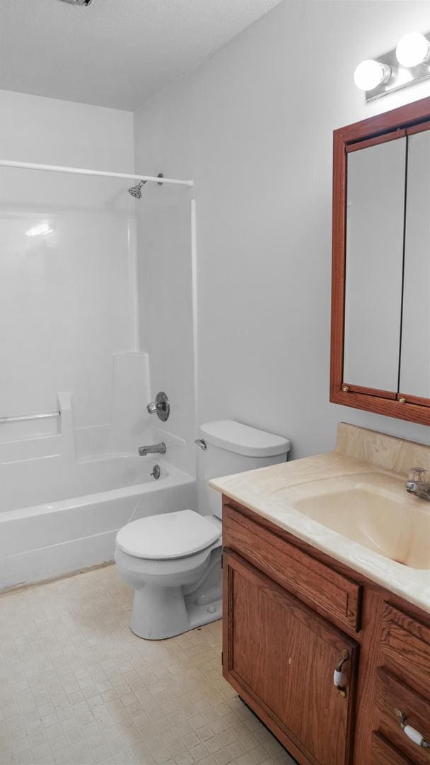 bathroom featuring shower / bath combination, vanity, toilet, and tile patterned floors