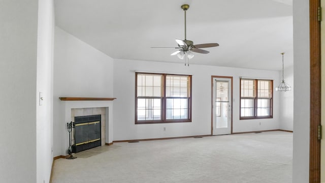 unfurnished living room with carpet floors, a fireplace, lofted ceiling, ceiling fan, and baseboards