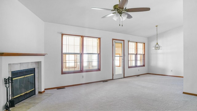 unfurnished living room with carpet, visible vents, a fireplace, and ceiling fan