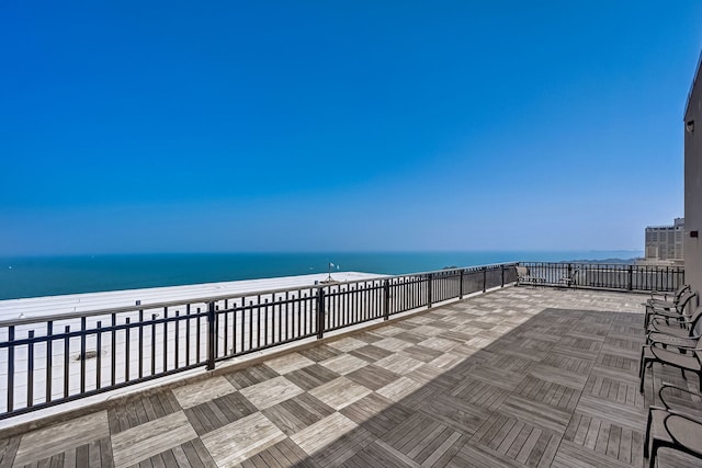 view of patio / terrace featuring a water view and a view of the beach