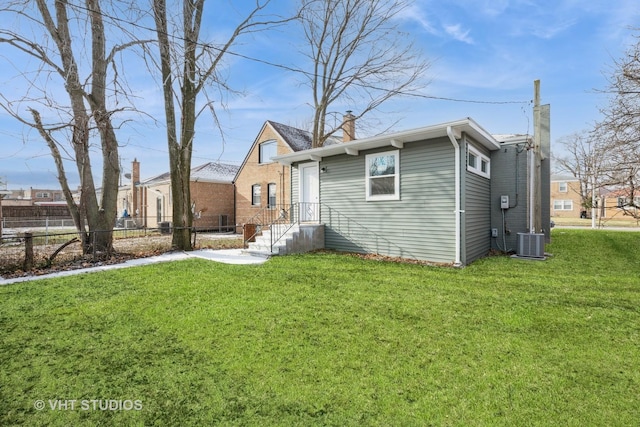 exterior space with a front lawn and central AC unit