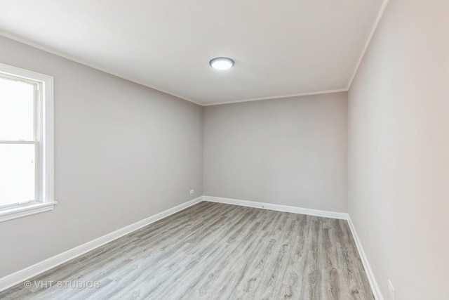 unfurnished room featuring light hardwood / wood-style flooring and crown molding