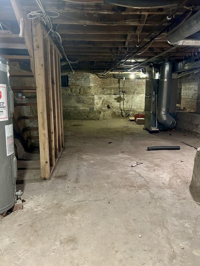 basement featuring electric water heater and heating unit