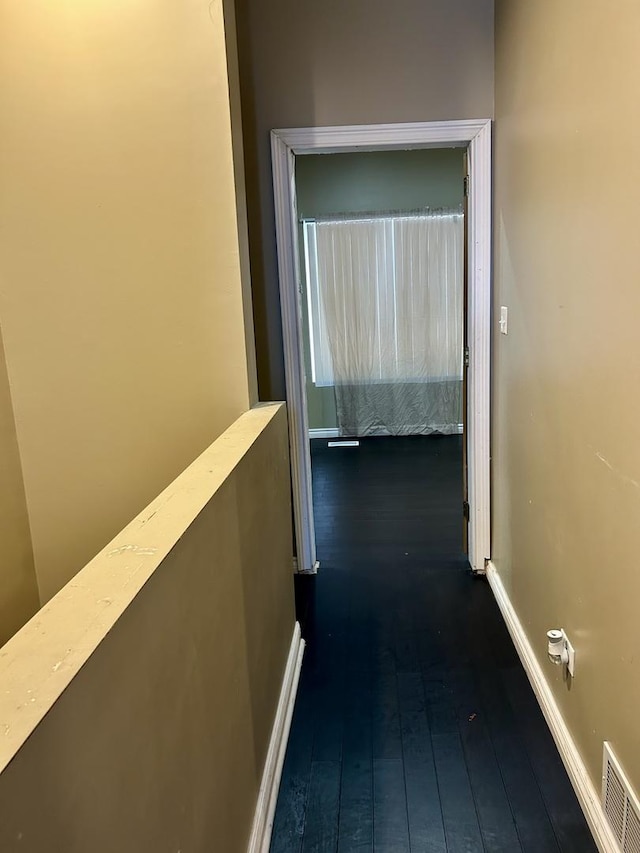 hallway with dark hardwood / wood-style floors