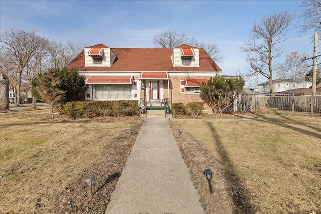 new england style home featuring a front lawn