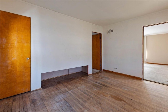 unfurnished room with hardwood / wood-style flooring