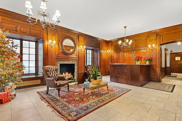 welcome area featuring a notable chandelier and a fireplace