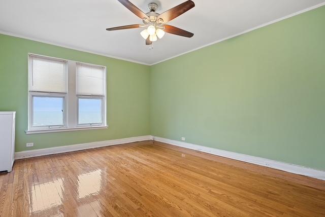 spare room featuring ceiling fan, crown molding, and light wood-type flooring